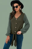 Close-up shot of soft apricot button-down cardigan sweater texture