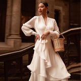 Woman in a white dress holding a woven basket in an urban setting