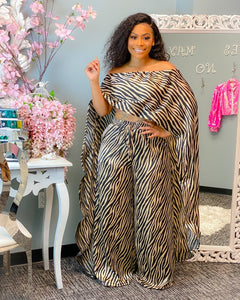 Woman wearing an apricot 2-piece African dashiki tunic top and matching wide-leg pants set.