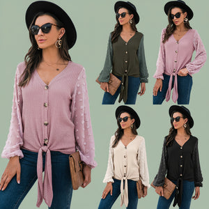 Woman wearing cozy pink V-neck knit cardigan sweater paired with jeans