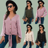 Woman wearing cozy pink V-neck knit cardigan sweater paired with jeans