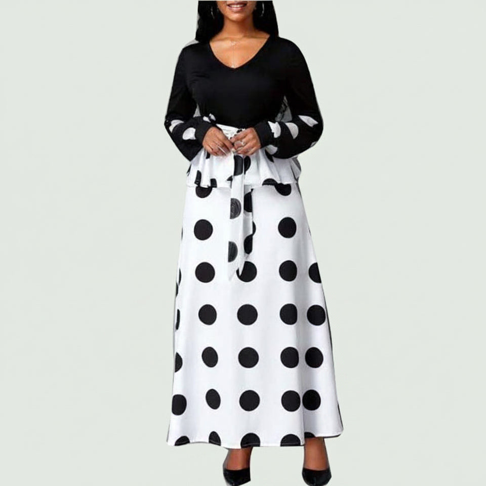 Front view of a woman wearing a black mesh polka dot high-waist maxi dress
